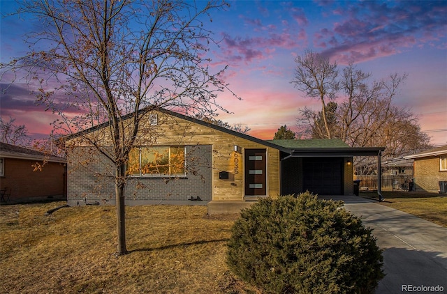 view of front of home with a lawn and a garage