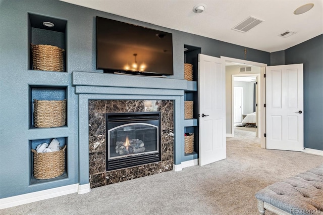 living room featuring a premium fireplace and carpet