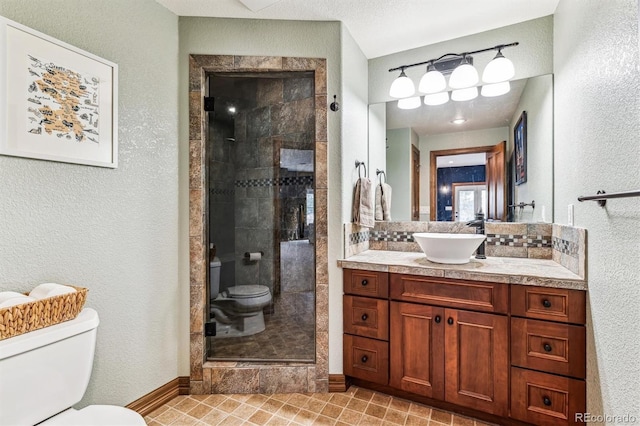 bathroom with walk in shower, vanity, and toilet