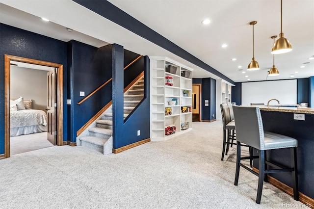 interior space with light carpet and decorative light fixtures