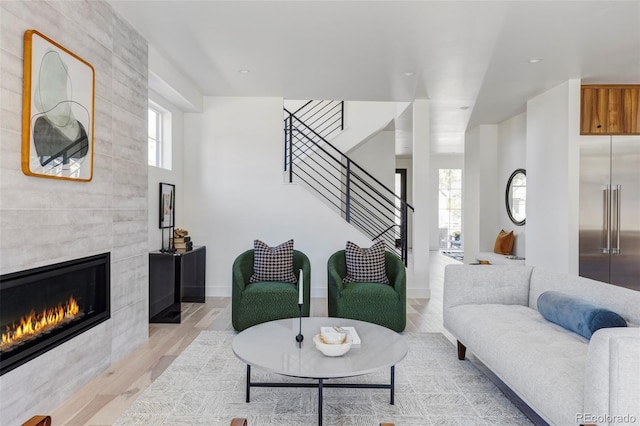 3362 W 32nd Ave, Denver, CO 80211 - living room with light wood-type flooring, a tile fireplace, stairway, baseboards, and recessed lighting