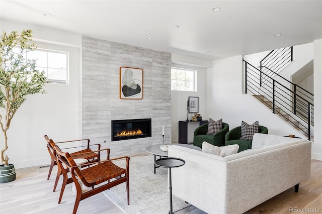 3362 W 32nd Ave, Denver, CO 80211 - living area with a tiled fireplace, wood finished floors, stairs, baseboards, and recessed lighting