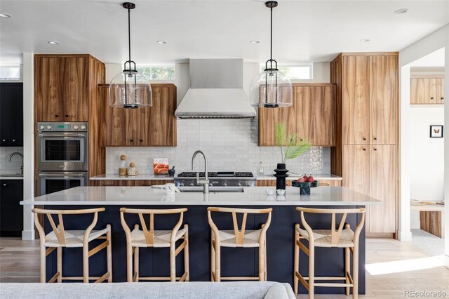 3362 W 32nd Ave, Denver, CO 80211 - kitchen with wall chimney exhaust hood, double oven, tasteful backsplash, light countertops, and modern cabinets