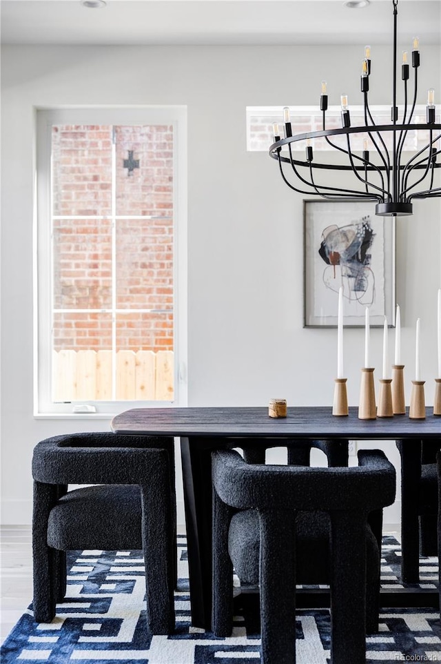 dining space featuring an inviting chandelier and hardwood / wood-style flooring