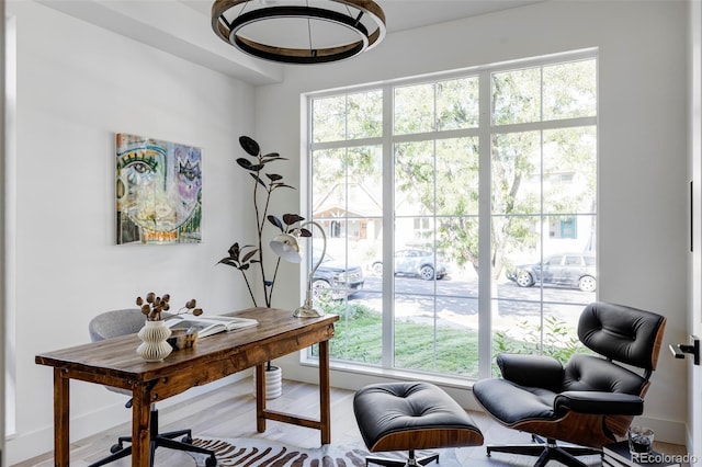 office area with hardwood / wood-style flooring and a healthy amount of sunlight