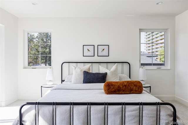 bedroom with multiple windows and carpet floors