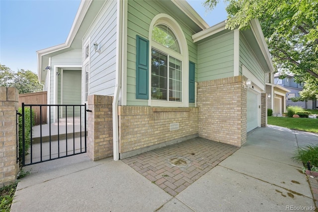 10231 Spotted Owl Ave, Highlands Ranch, CO 80129 - view of home's exterior with brick siding, driveway, and an attached garage