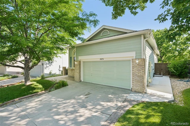 10231 Spotted Owl Ave, Highlands Ranch, CO 80129 - view of front of home featuring brick siding, concrete driveway, and a front lawn