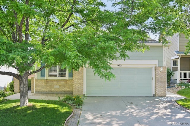 10231 Spotted Owl Ave, Highlands Ranch, CO 80129 - view of property hidden behind natural elements featuring brick siding, concrete driveway, and an attached garage