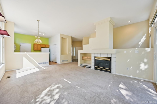 10231 Spotted Owl Ave, Highlands Ranch, CO 80129 - unfurnished living room featuring carpet and a tile fireplace
