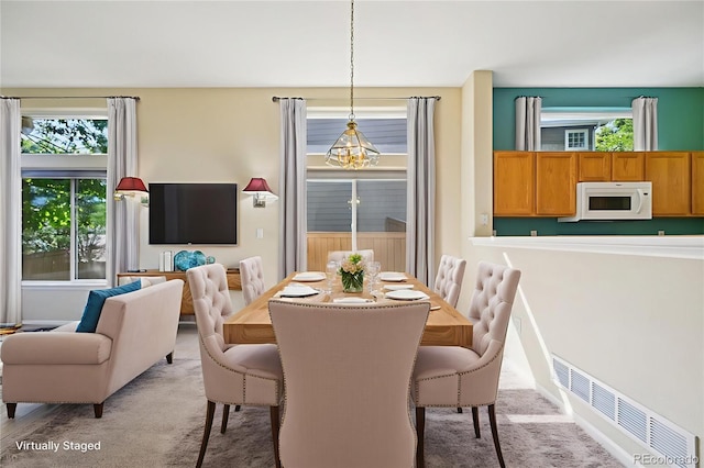 10231 Spotted Owl Ave, Highlands Ranch, CO 80129 - dining area featuring plenty of natural light, light carpet, and a chandelier