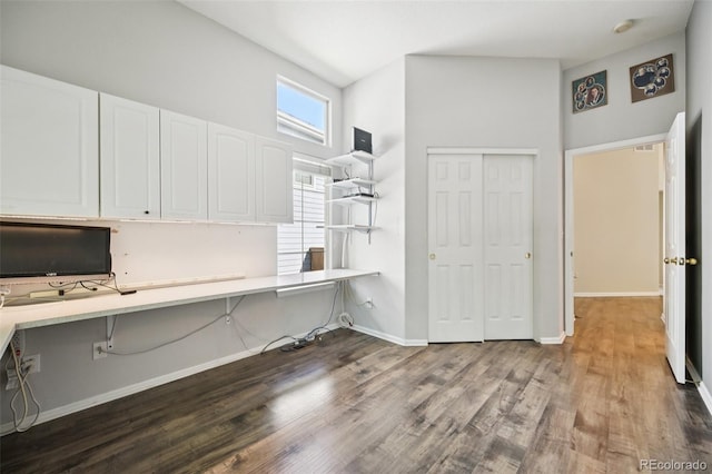 10231 Spotted Owl Ave, Highlands Ranch, CO 80129 - unfurnished office featuring wood finished floors, built in desk, and a high ceiling