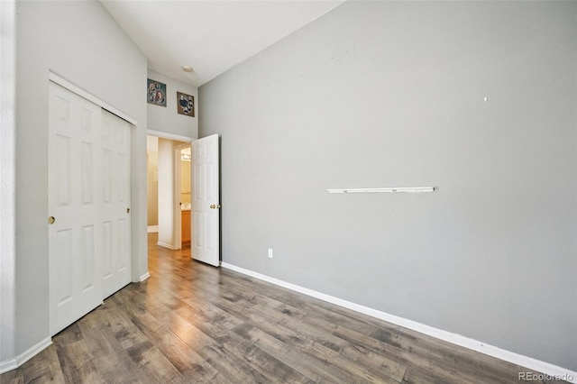 10231 Spotted Owl Ave, Highlands Ranch, CO 80129 - unfurnished bedroom with wood finished floors, vaulted ceiling, and a closet