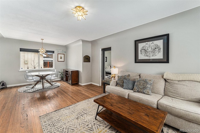 living area featuring wood-type flooring and baseboards