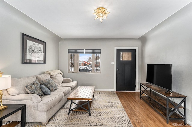 living area with wood finished floors and baseboards