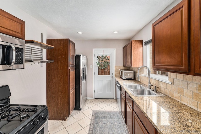 kitchen with open shelves, stainless steel appliances, backsplash, light tile patterned flooring, and a sink