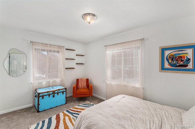 carpeted bedroom featuring baseboards