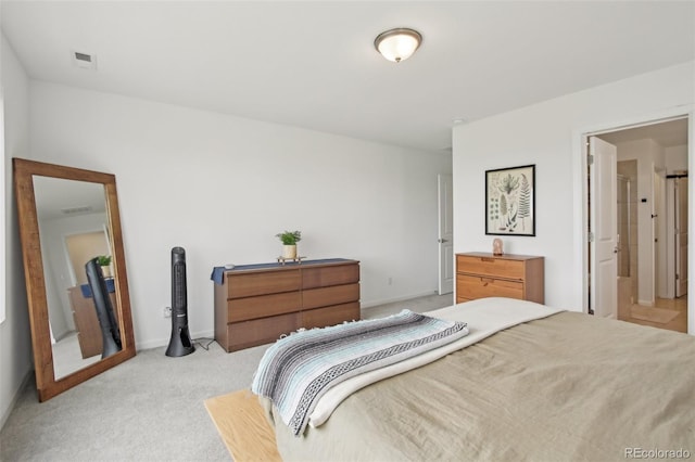 bedroom with baseboards, visible vents, and light carpet