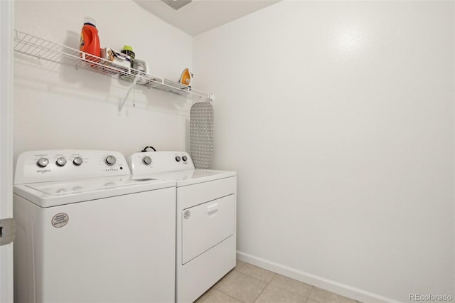 laundry room with independent washer and dryer, laundry area, baseboards, and light tile patterned floors