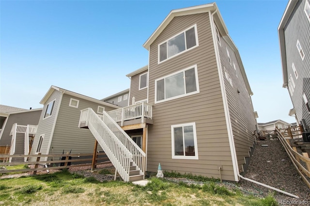 back of house with a wooden deck, stairs, and a fenced backyard