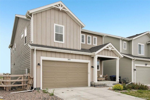multi unit property featuring an attached garage, board and batten siding, fence, and driveway