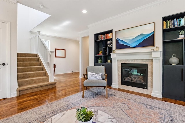 8695 E 49th Pl, Denver, CO 80238 - living room featuring wood finished floors, stairway, built in features, crown molding, and recessed lighting