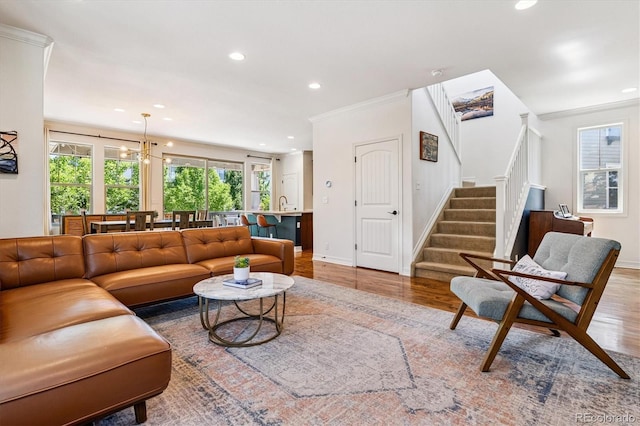 8695 E 49th Pl, Denver, CO 80238 - living room featuring stairway, wood finished floors, recessed lighting, crown molding, and a chandelier