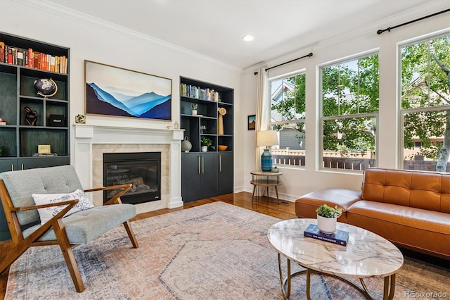 8695 E 49th Pl, Denver, CO 80238 - living room with a glass covered fireplace, healthy amount of natural light, wood finished floors, built in shelves, and ornamental molding