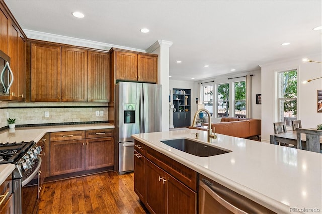 8695 E 49th Pl, Denver, CO 80238 - kitchen featuring stainless steel appliances, recessed lighting, light countertops, dark wood-style flooring, and decorative backsplash