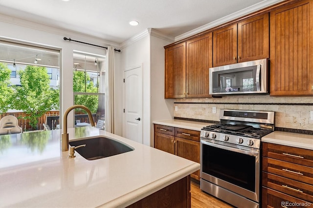 8695 E 49th Pl, Denver, CO 80238 - kitchen featuring stainless steel appliances, ornamental molding, backsplash, light countertops, and brown cabinetry