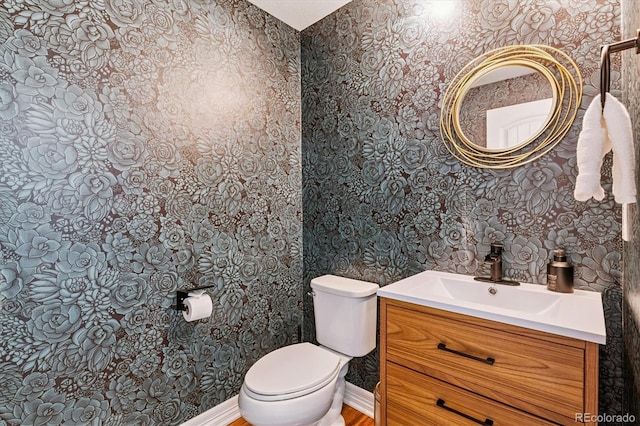 8695 E 49th Pl, Denver, CO 80238 - half bathroom featuring wallpapered walls and vanity