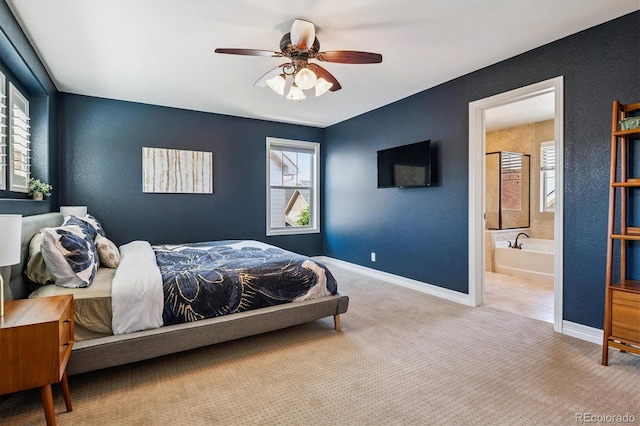 8695 E 49th Pl, Denver, CO 80238 - bedroom with multiple windows, ensuite bathroom, carpet flooring, and ceiling fan