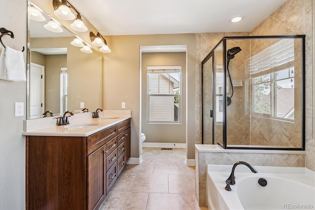 8695 E 49th Pl, Denver, CO 80238 - bathroom with a bath, double vanity, a stall shower, and tile patterned flooring