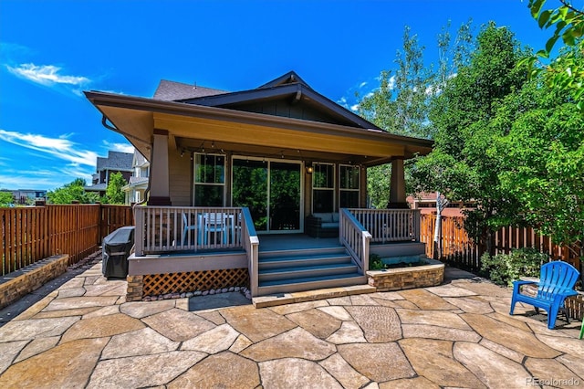 8695 E 49th Pl, Denver, CO 80238 - fenced backyard featuring a patio area, area for grilling, and a wooden deck