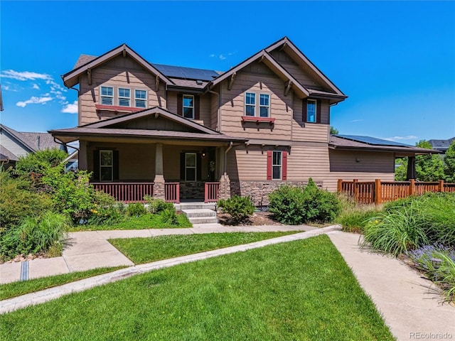 8695 E 49th Pl, Denver, CO 80238 - craftsman house with a porch, solar panels, a front yard, and stone siding