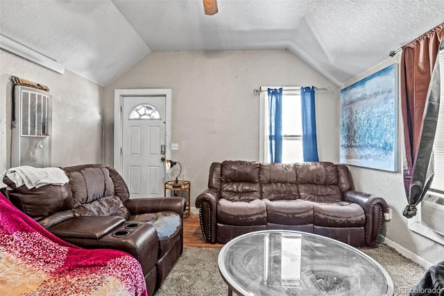 carpeted living room featuring a textured ceiling and lofted ceiling