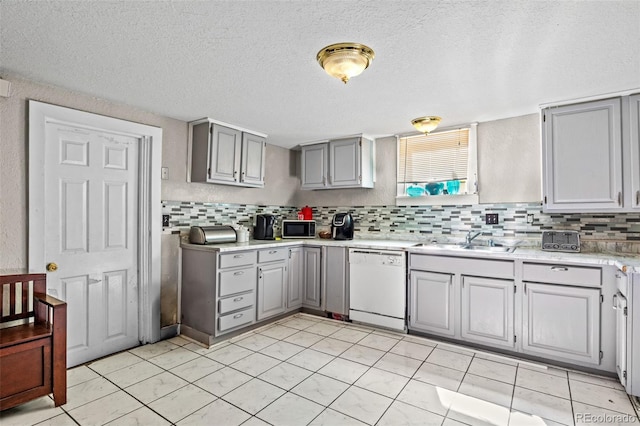 kitchen featuring gray cabinets, a textured ceiling, sink, decorative backsplash, and white dishwasher