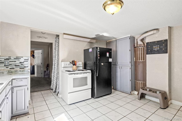 kitchen featuring decorative backsplash, white appliances, light tile patterned floors, and gray cabinets