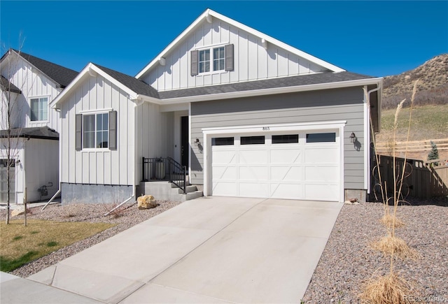 modern farmhouse style home featuring board and batten siding, a mountain view, a garage, and concrete driveway