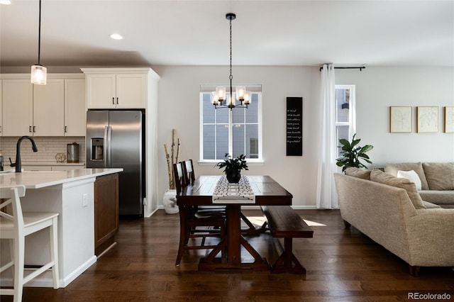 kitchen featuring an inviting chandelier, tasteful backsplash, recessed lighting, stainless steel refrigerator with ice dispenser, and light countertops