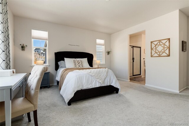 bedroom with light carpet, baseboards, and connected bathroom