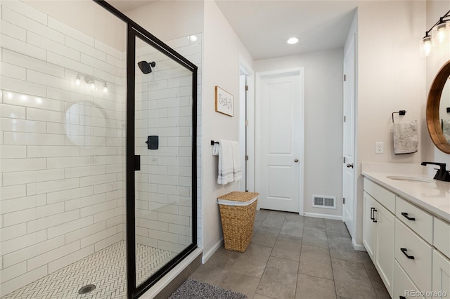 full bath with vanity, baseboards, recessed lighting, a shower stall, and visible vents