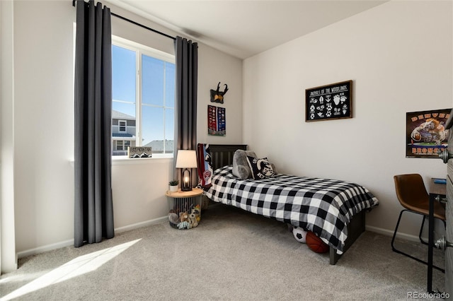 carpeted bedroom featuring multiple windows and baseboards