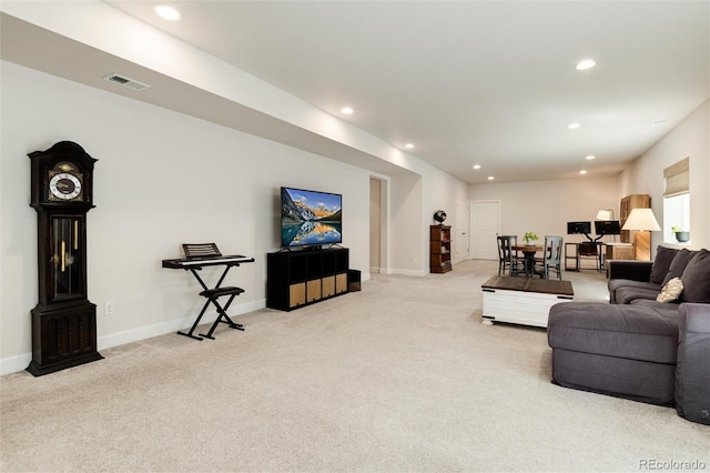 carpeted living area with baseboards, visible vents, and recessed lighting
