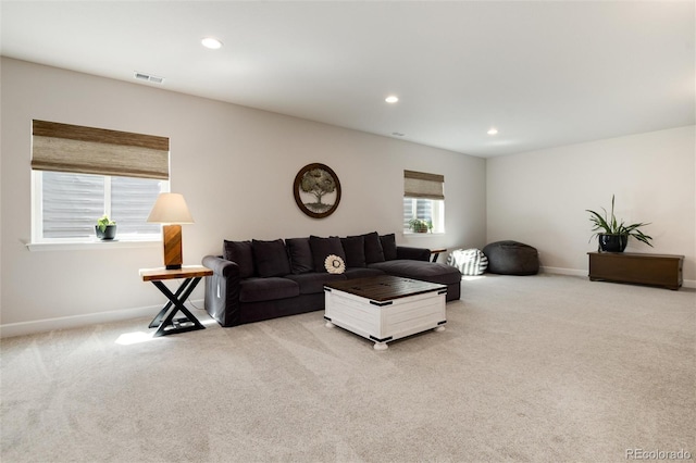 living area featuring visible vents, baseboards, carpet, and recessed lighting