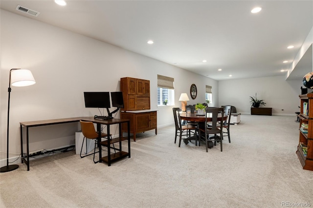 dining area featuring light colored carpet and recessed lighting