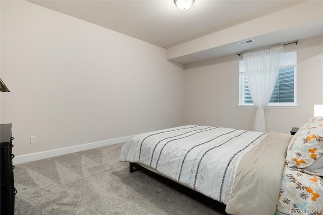 carpeted bedroom with visible vents and baseboards