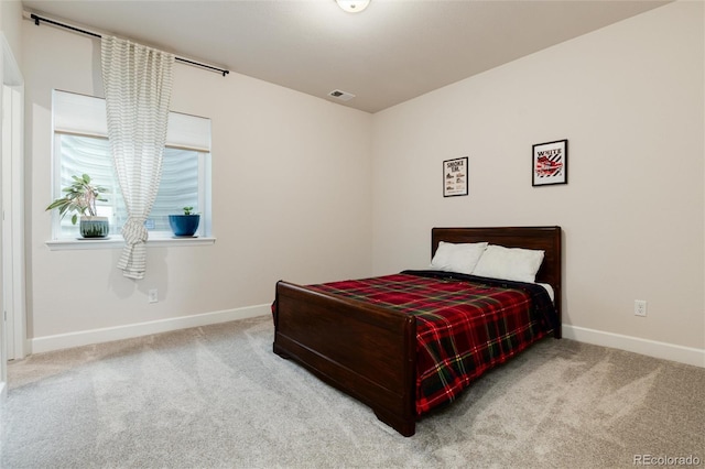 carpeted bedroom featuring visible vents and baseboards