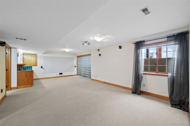 basement featuring baseboards and visible vents