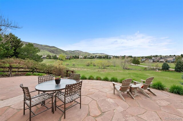 view of patio with a mountain view and outdoor dining space